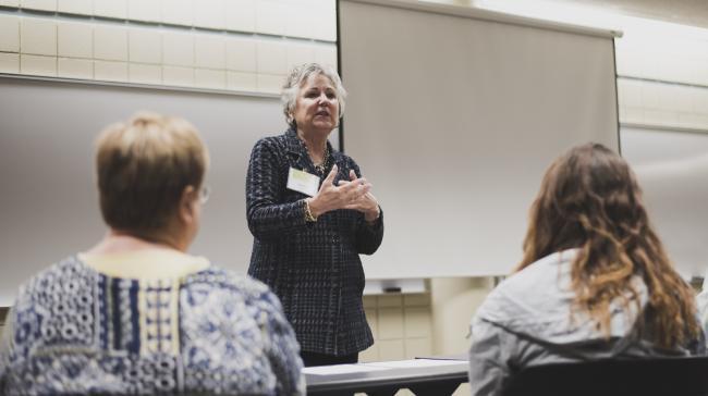 Former trustee Deb Bailey leading an discussion.