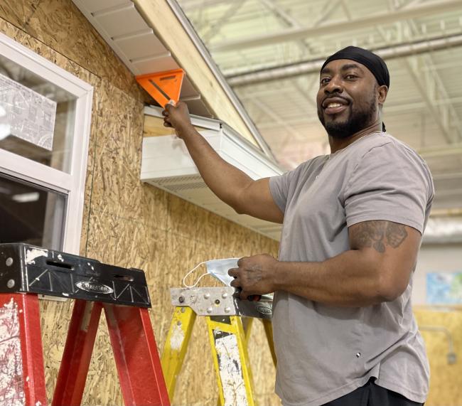 Derrick Peoples working on building a shed.