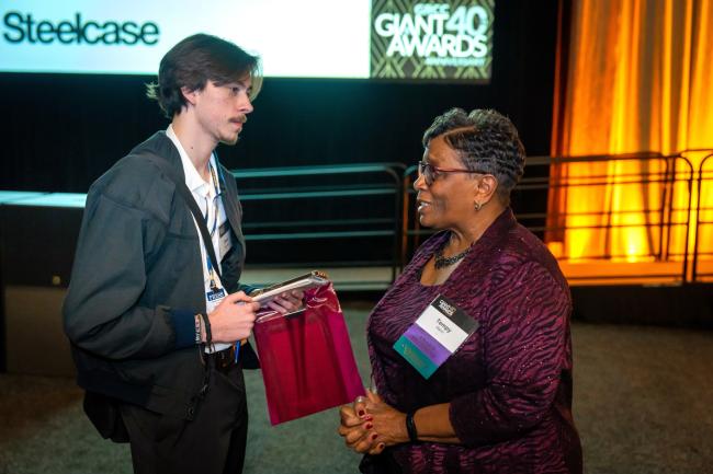 Collegiate reporter David Carpenter interviewing one of the organizers of the GIANT Awards. 
