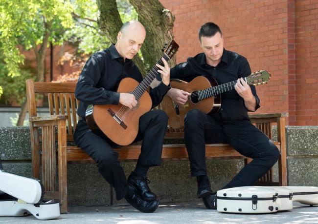 Brian Morris and Jonathan Marshall practicing with their guitars.