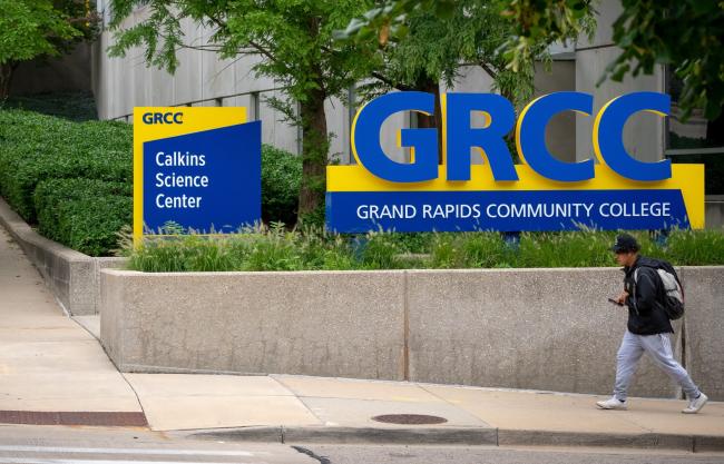Student walking past new signs on Bostwick Ave.