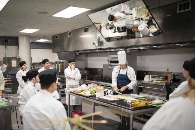 Chefs and students working in GRCC's kitchen classroom.