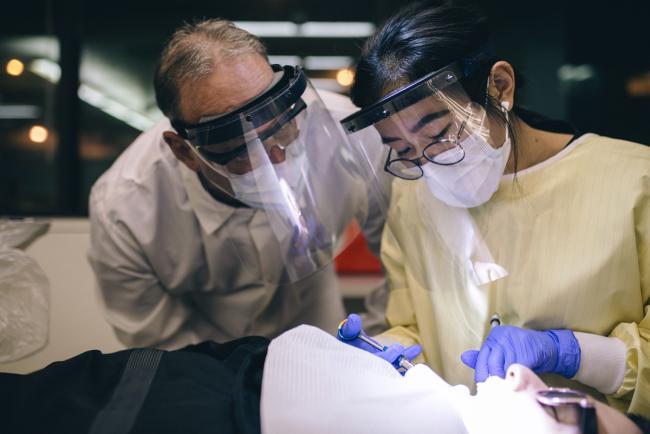 Dental student working with an instructor. 