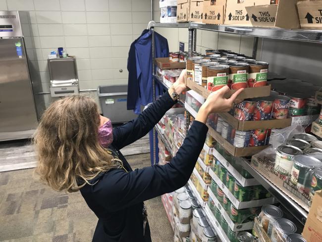 GRCC staff member Ashley Fox socks items in the campus food pantry. 