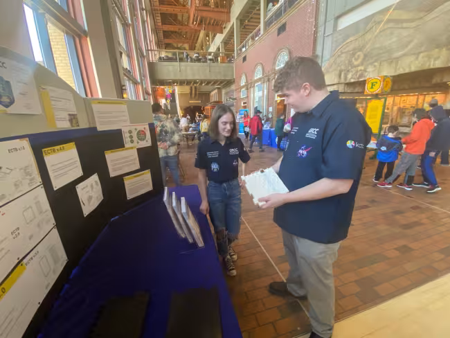 Abby Tichelaar and Cole Herring discussing their project at the Grand Rapids Public Museum.