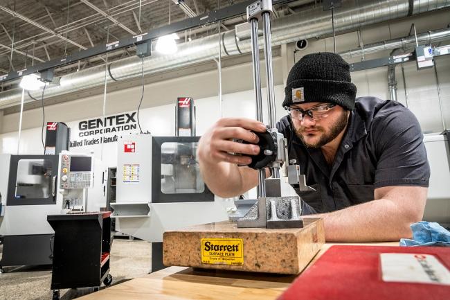 A Workforce Student working with measuring tools at the GRCC Lakeshore Campus.