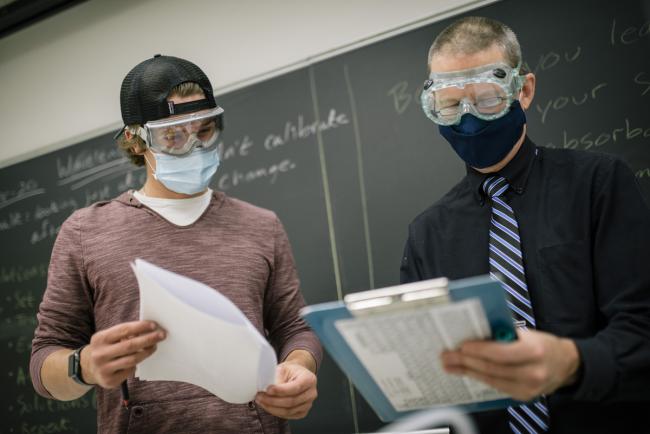 A student and professor in a Chemistry class.