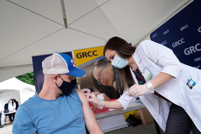 Student getting a vaccine at a GRC clinic in May.