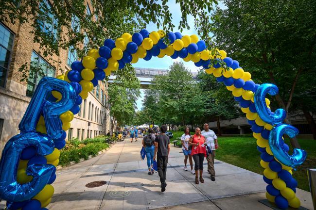 Students walking under a balloon arch on Service Saturday.