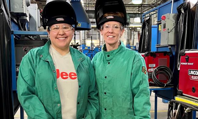 Tanya Contreras and Cheyenne Belonga photographed with welding hoods on their heads