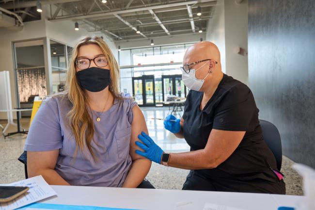 A student receiving a vaccination at a campus clinic.