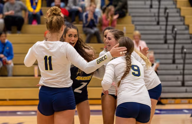 GRCC volleyball players celebrating.