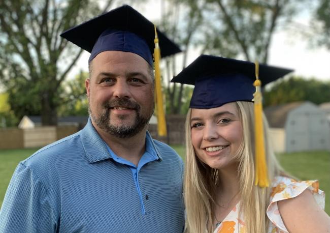 Erin and Hannah Widenmuller posing with their mortarboards.