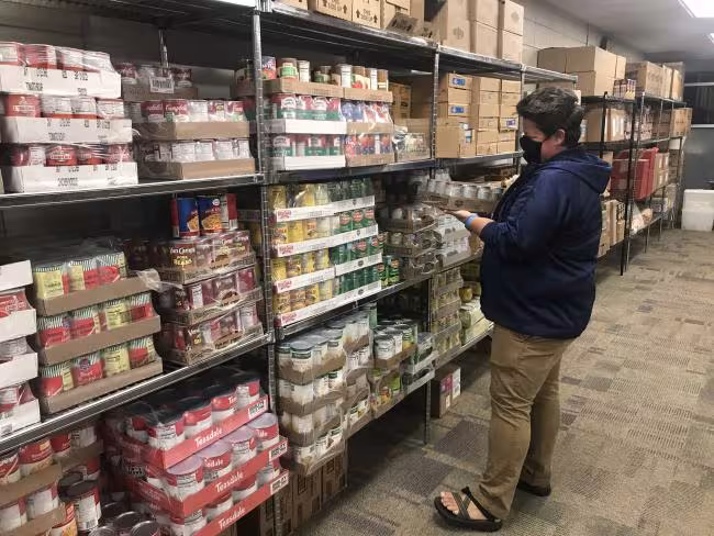 Lina Blair restocking the GRCC Food Pantry
