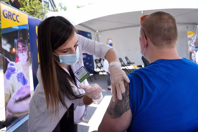 Student getting a vaccination at a GRCC clinic.