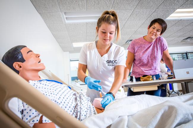 GRCC Nursing student working with a professor.