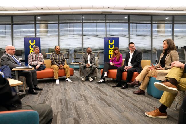 Students and staff sitting with Lt. Gov. Gilchrist in the computer lab at GRCC. 