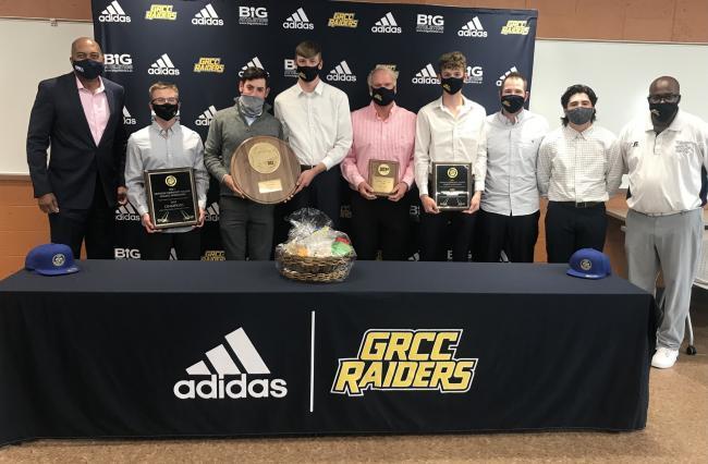 Members of the golf team pose with President Pink and AD Dave Selmon.