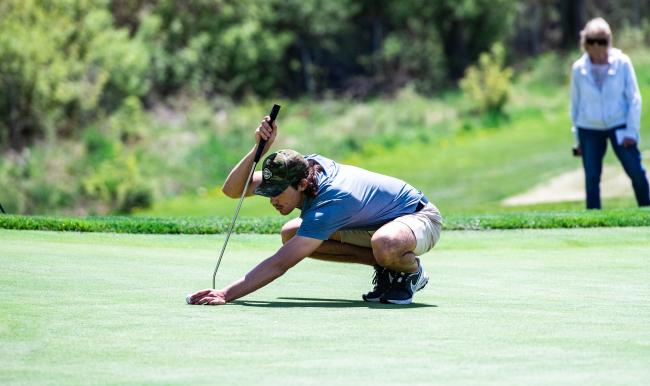 GRCC golfer lining up a putt on the green. 