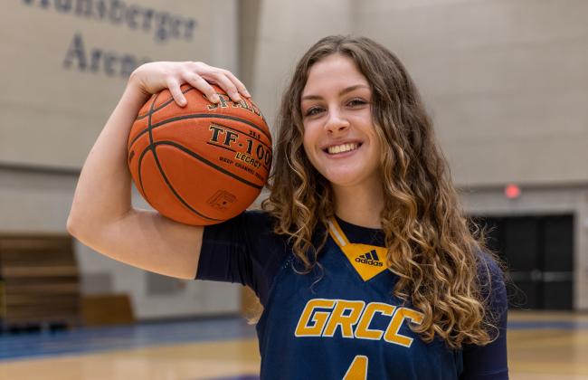 Grace Lodes posing with a basketball.