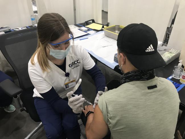 GRCC Nursing student administers vaccination at DeVos Place.