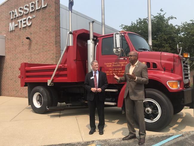 Kentwood Mayor Stephen Kepley and GRCC President Pink stand near the donated truck.