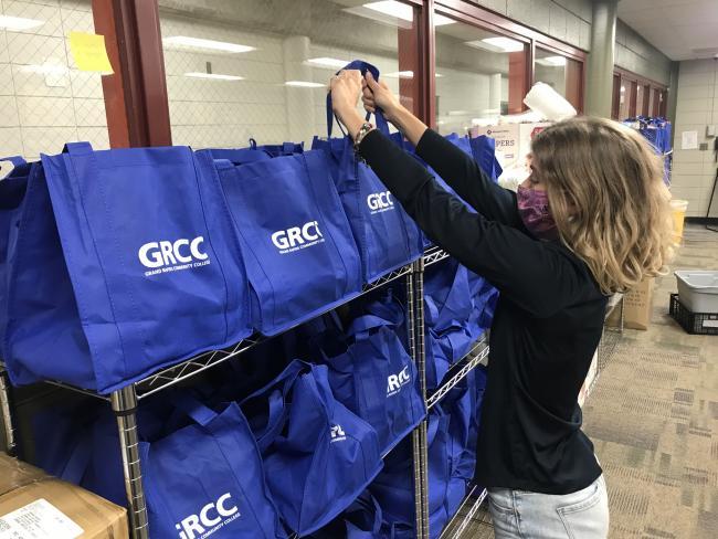 Ashley Fox helps restock the GRCC food pantry