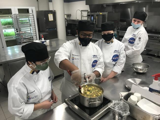 Students Olivia Sandoval, Chris Quezada, Elizabeth Afton and Grace Haaksma working in the Secchia kitchens.