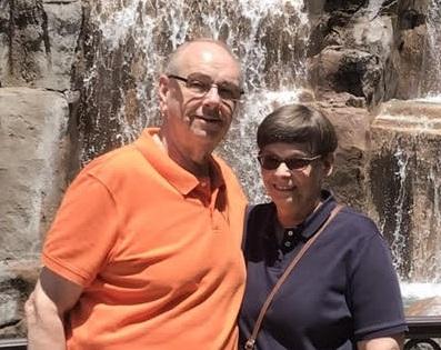 Jerry and Jan Benham posing near a waterfall.
