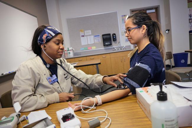 Medical assistant students taking blood pressure