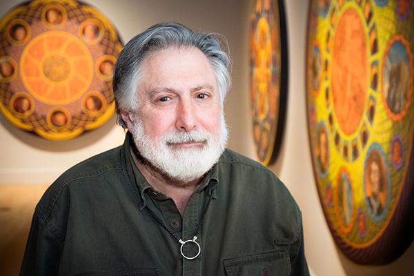 Portrait of Jay Constantine with his artwork. 