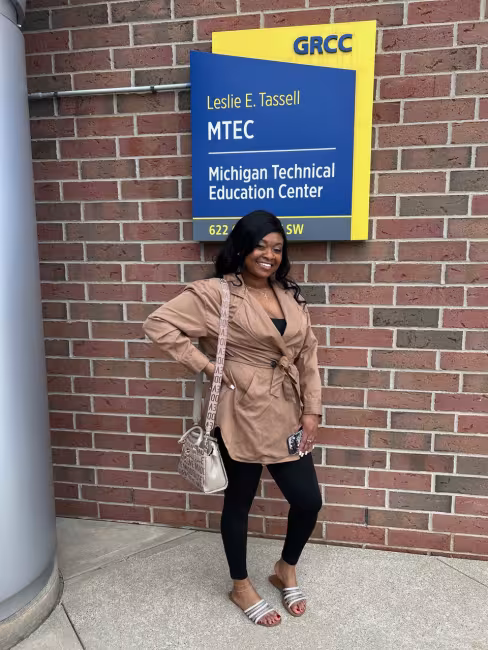 Juané Lancaster stands in front of the GRCC Leslie E. Tassell Michigan Technical Education Center