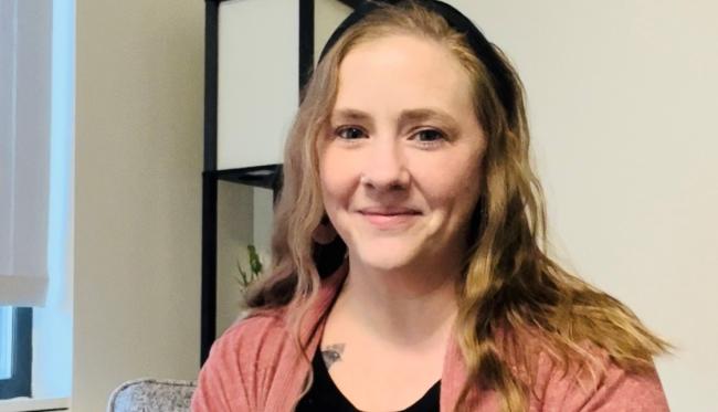 Caitlin Owens posing in her living room.