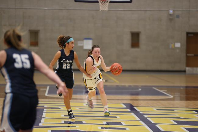 Marlene Bussler driving to a basket.