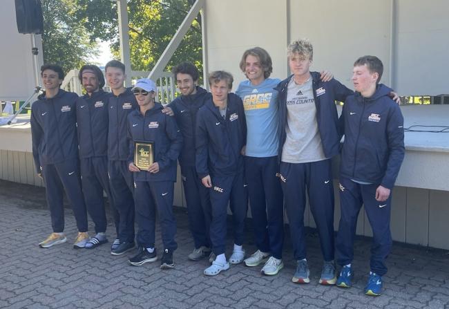Men's cross country team posing with its trophy after the race.