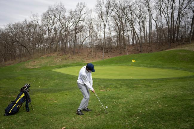 GRCC golfer looking to chip a ball onto the green.