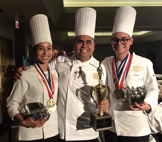 Students from Team Mexico and their coach pose with their awards and medals after winning the Nations Cup