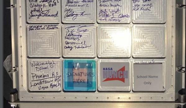 Signatures of GRCC students on NASA equipment, above the blue box. 