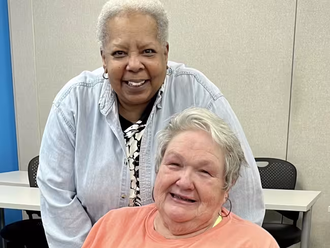 Paulette Moncure and Sherry Wagner sitting together.