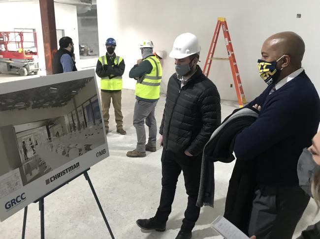 GRCC President Pink looking at renderings during a tour of the Lakeshore Campus construction.