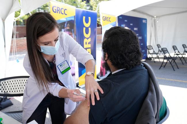 A GRCC student receives a COVID-19 vaccine at a May clinic on campus.