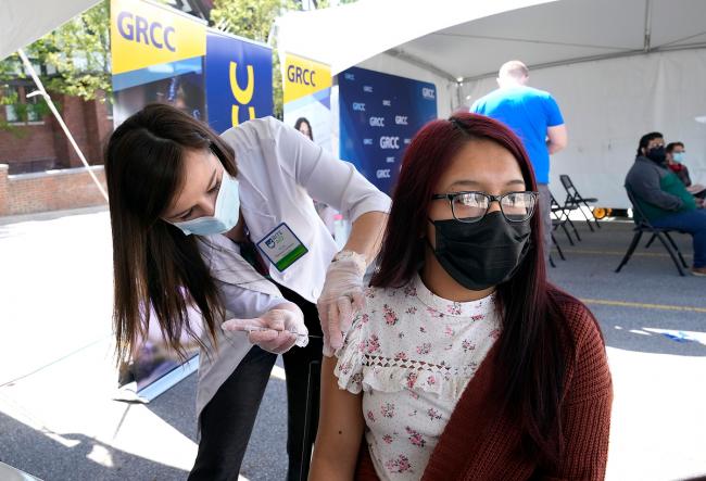A GRCC student receiving the COVID vaccination at a campus clinic.