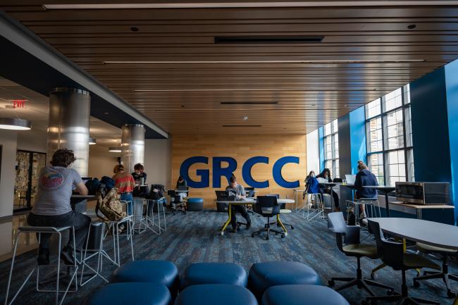 Students sit in a common area and study.