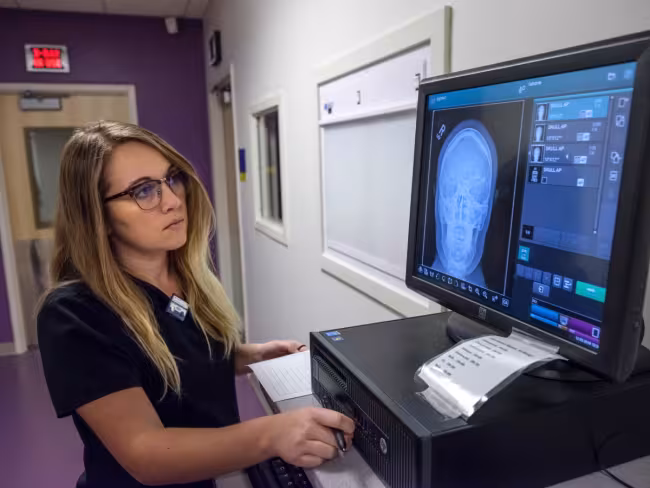 A rad tech student working on x-ray training equipment.