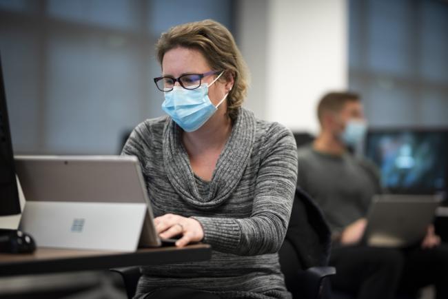 Student working on a laptop in a business class.