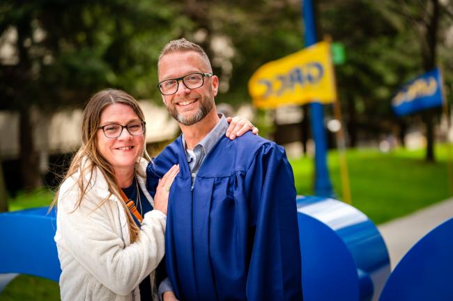 Ron Moore and his wife, Jennifer, at commencement.