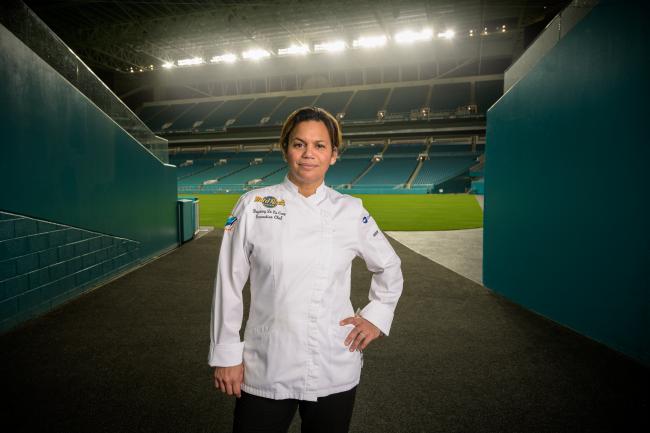 Chef Dayanny De La Cruz stands near the field at Hard Rock Stadium in Miami.