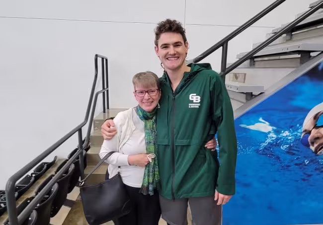 Sara Anne Hook and Eric at a swim meet.