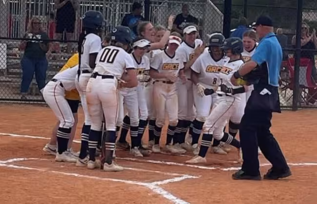 GRCC softball team celebrating after a home run.