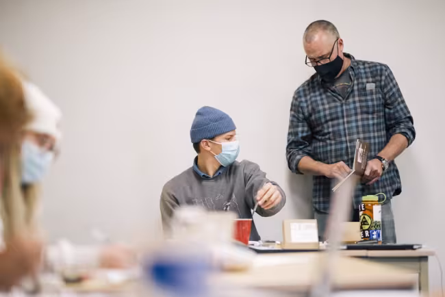 Matthew Schenk working with an art student. 